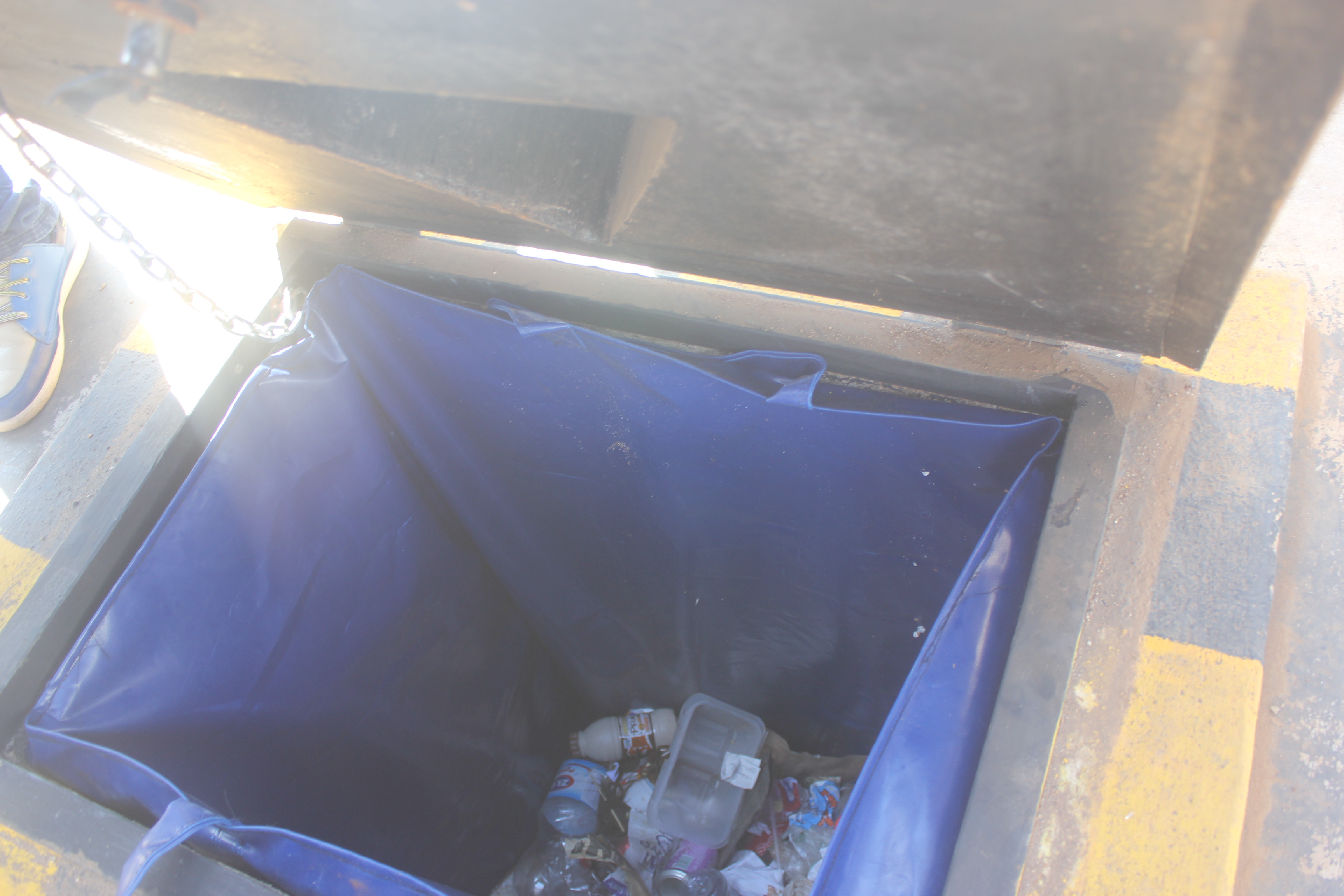 Rubbish in an opened underground bin